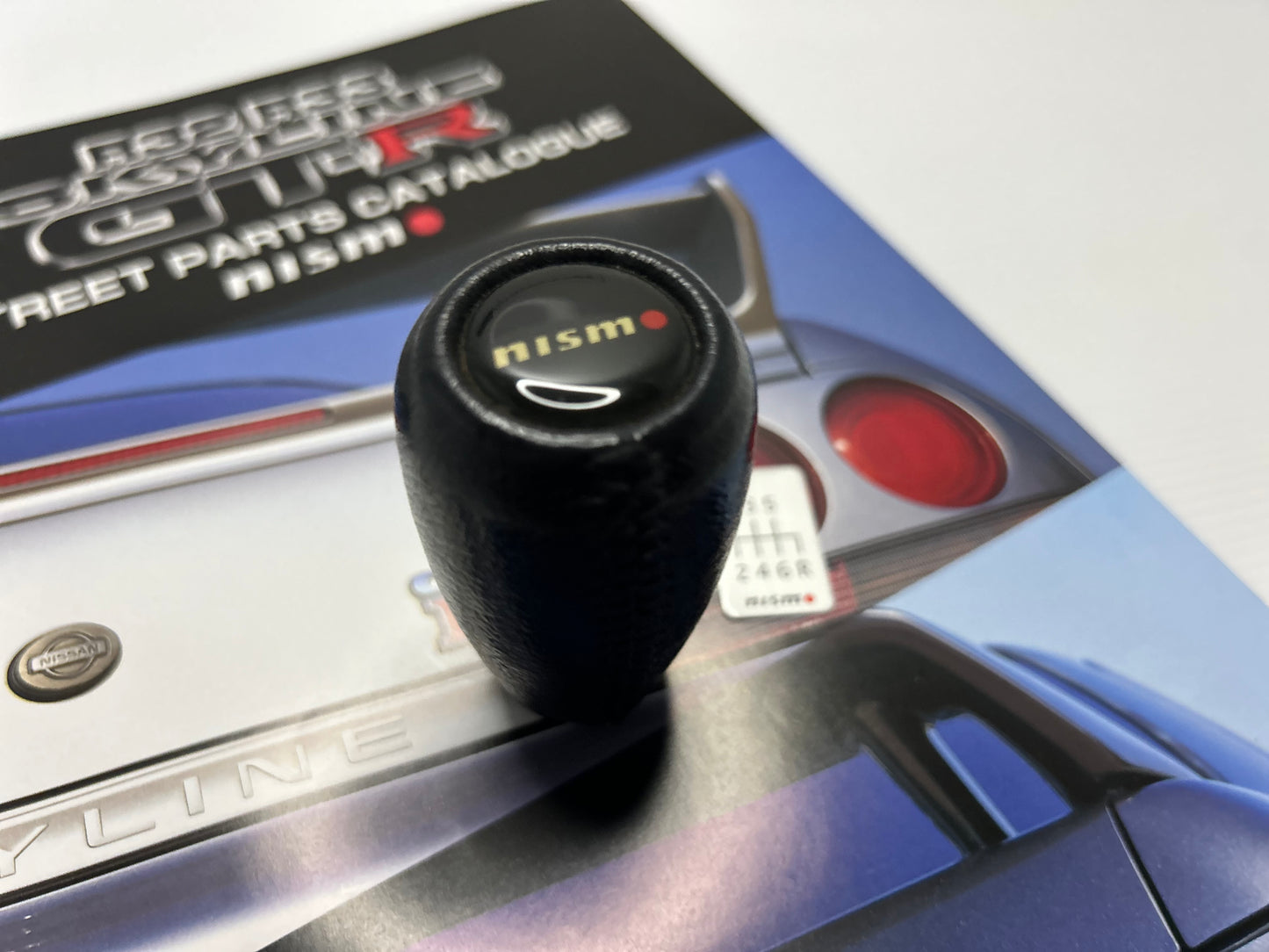 Nismo Mid Logo Shift Knob with shift Emblem - Black / Leather